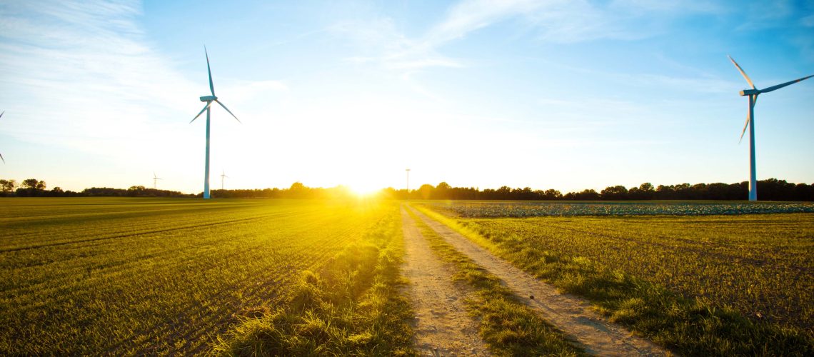 Windmills on the field at sunset. Alternative ecological energy.