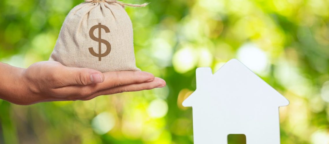 world-habitat-day-close-up-picture-of-a-sack-of-coins-and-a-model-house-1024x683